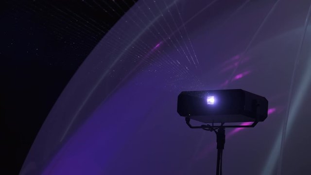 Light laser projector shining in nightclub