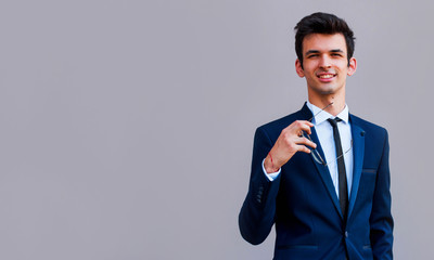 Young business man with glasses in hands