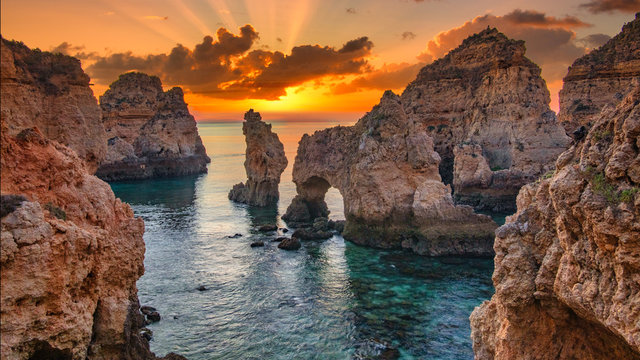 Sunrise over stunning cliffs and arches in Ponta da Piedade, Lagos, Algarve, Portugal