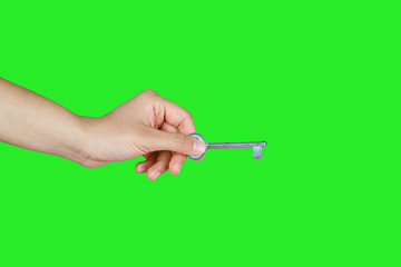 House key in woman hand. green background