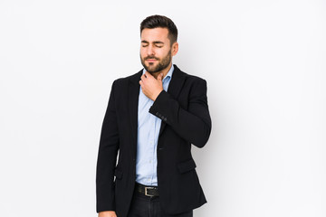 Young caucasian business man against a white background isolated suffers pain in throat due a virus or infection.