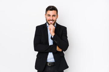 Young caucasian business man against a white background isolated smiling happy and confident,...
