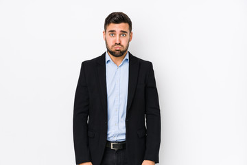 Young caucasian business man against a white background isolated blows cheeks, has tired expression. Facial expression concept.