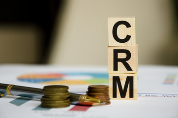 word written on cubes near financial statements and coins