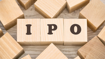 black letters ipo on small wooden blocks and empty details