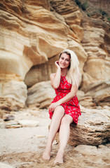 
woman sitting on rocks near the sea