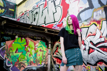 Fototapeta premium Close-up Fashion woman portrait of a girl with green - pink hair. Summer street fashion.