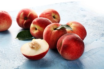 Naklejka na ściany i meble A group of ripe peaches on wooden table