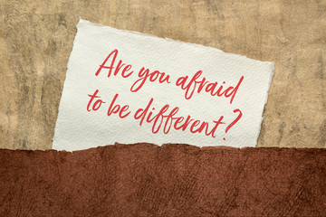 Are you afraid to be different? Handwriting on a handmade paper. Business, education and personal development concept.