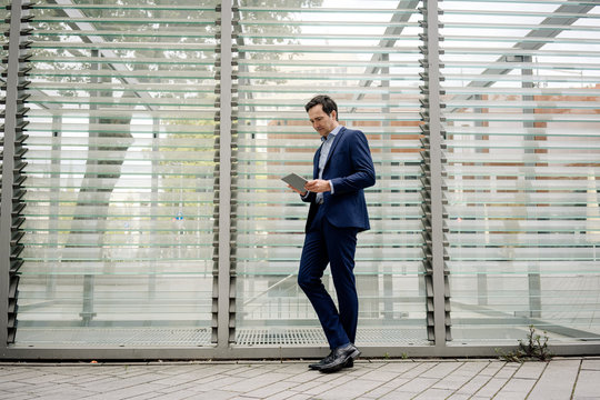 Mature businessman using tablet in the city