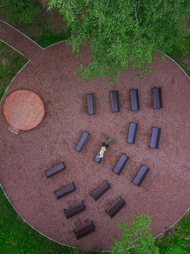 Aerial view of woman lying down on bench in park