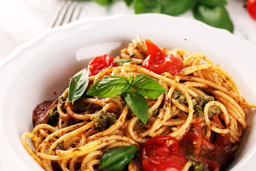 Plate of delicious spaghetti Bolognaise or Bolognese with savory minced beef and tomato sauce garnished with parmesan