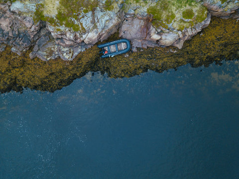 Russia, Murmansk region, Kolsky District, Teriberka, Boat at rocky coast