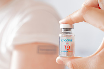 Vial with vaccine for covid-19 coronavirus, flu, infectious diseases. Patient hand with blue stamp vaccinated. Injection after clinical trials for human, child, adult, senior. Medicine,drug concept