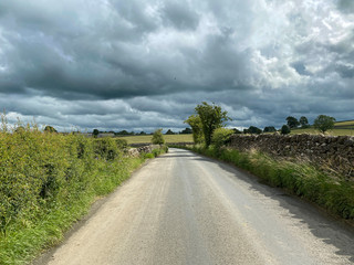 The road to Kirby Malham, with heavy rain clouds above