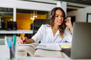 Distance learning. Young business woman, student, teacher, tutor wear wireless headset video...