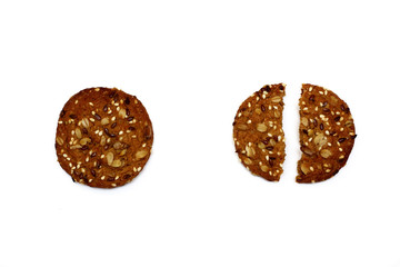Two oatmeal cookies with cereals whole and broken isolated