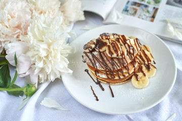 pancakes drizzled with chocolate and banana