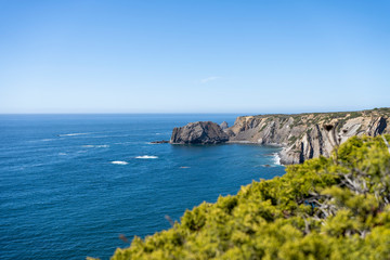 Fototapeta na wymiar Wild untouched empty secret beach seascape. Seaside view from the cliffs to the ocean. Sea landscape
