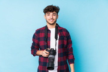 Young arab photographer man isolated happy, smiling and cheerful.
