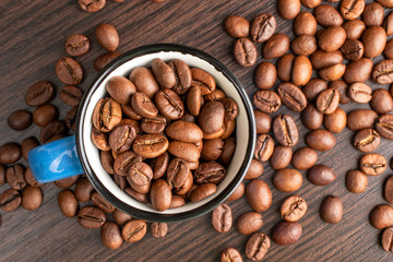 Roasted coffee beans in a cup background. International coffee day concept.