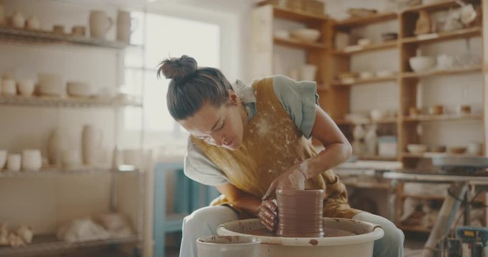 Talented artist makes clay bowl on pottery wheel, handmade creative artist