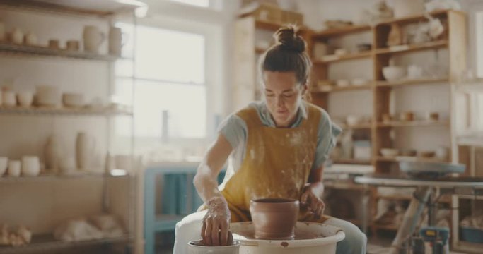 Talented artist makes clay bowl on pottery wheel, handmade creative artist