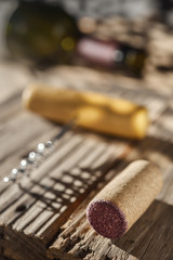 Wine cork, corkscrew and bottle of wine on the table