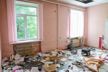 Room of an old abandoned building filled with trash on the floor