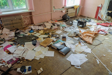 Room of an old abandoned building filled with trash on the floor