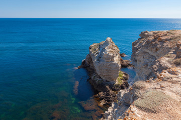 Seascape - Rocky coast washed by blue water