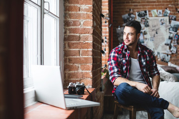 Man with laptop indoors.