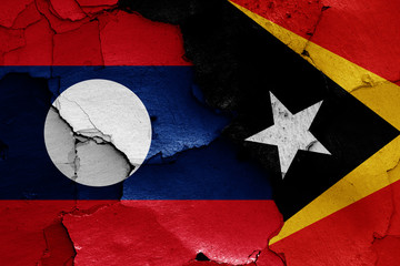 flags of Laos and East Timor painted on cracked wall