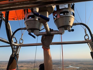 Hot air balloon flight in Alentejo, hand on the mechanism, Portugal