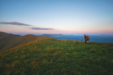 Obraz premium a man walks along a mountain range. 