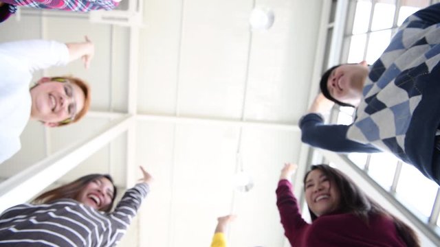 Business team show teamwork by putting hands together / low angle view.