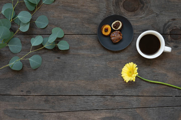 Black coffee and healthy snacks on a wooden table