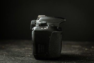 Side view of photo camera body on the black background