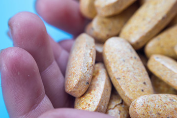 dietary supplement pills in the hand. herbal drug an alternative medicine