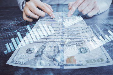 Multi exposure of forex graph drawing hologram and USA dollars bills and man hands. Technical Analysis concept.