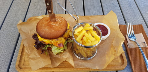 Delicious burgers with beef, tomato, cheese and lettuce