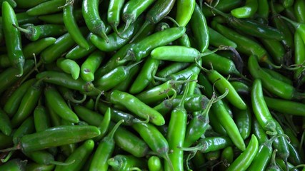 The close up on lot of fresh green chili peppers