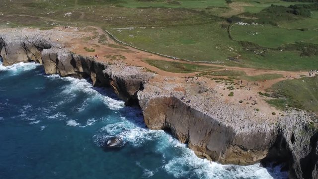 Asturias. Waves crashing against cliffs in Guadamia. Pria blowholes. Spain. Aerial  Footage