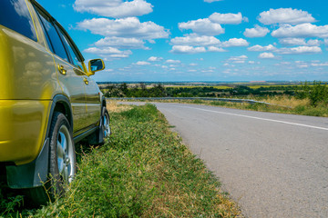 Sunny landscape with road, sky and car