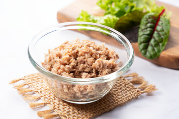 Tuna in a glass bowl set in a marble
