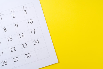 Close-up of a calendar on a yellow background