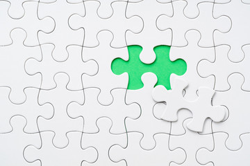 Fototapeta premium White Jigsaw Puzzle with Green Background