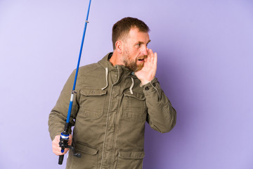 Senior fisherman isolated on purple background is saying a secret hot braking news and looking aside