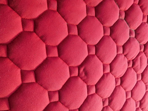 surface of old red saddle cloth for horse, texture of fabric close up