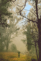 Tanti, Cordoba/ Argentina - July 5, 2017: Girl standing in a foggy forest